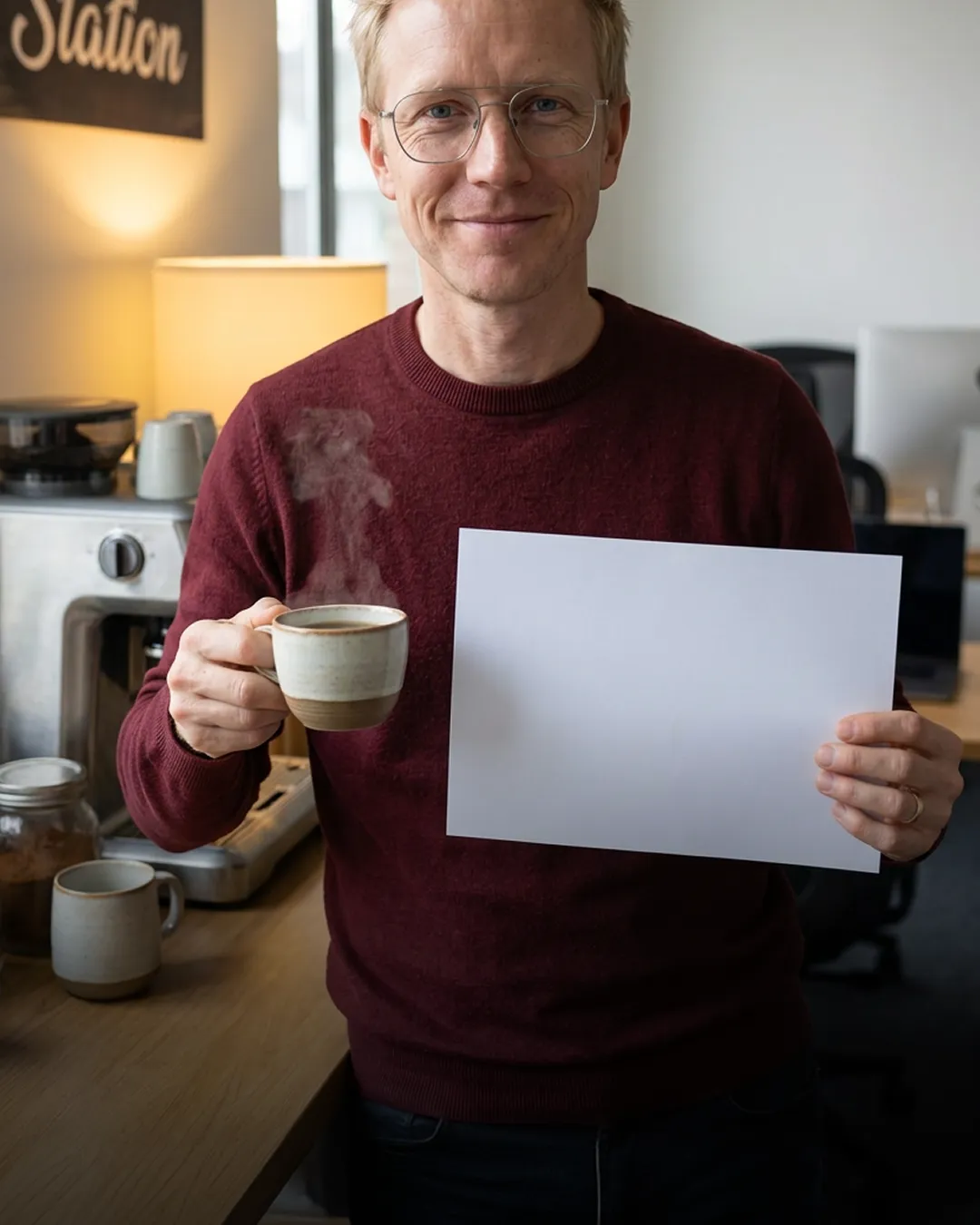 Consultant holding a coffee and a blank brief at his desk