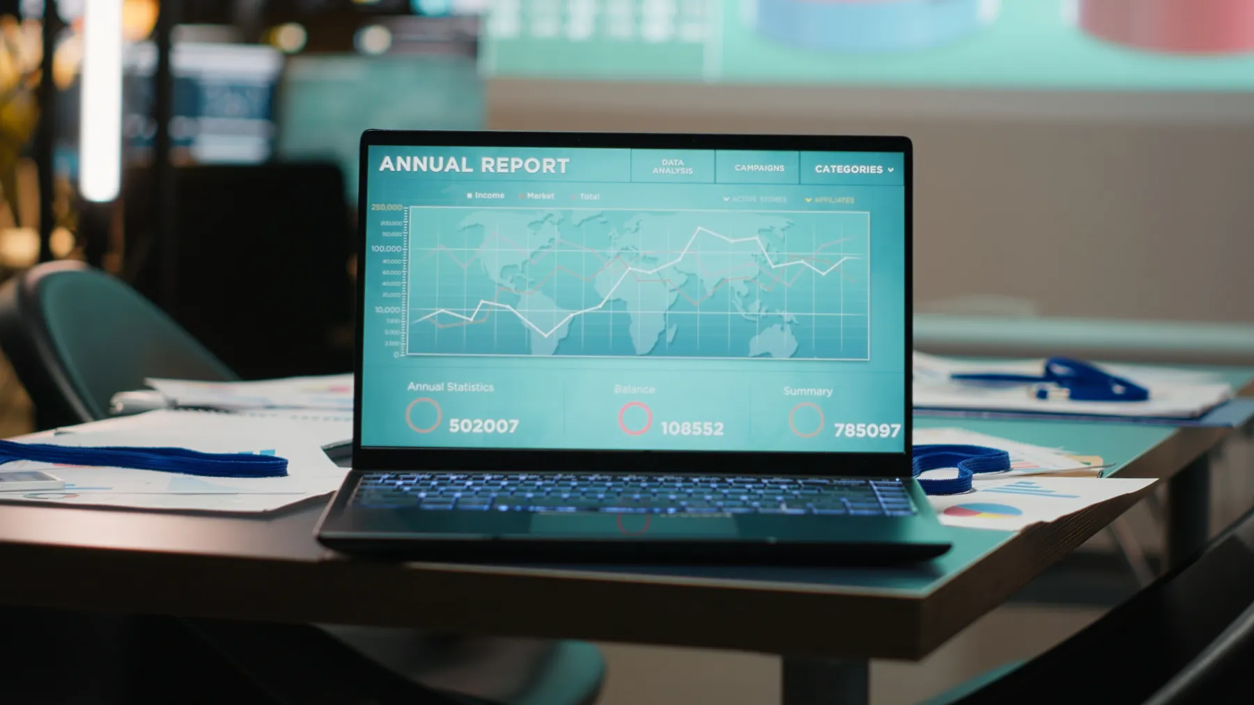 Laptop showing performance data in a dark office